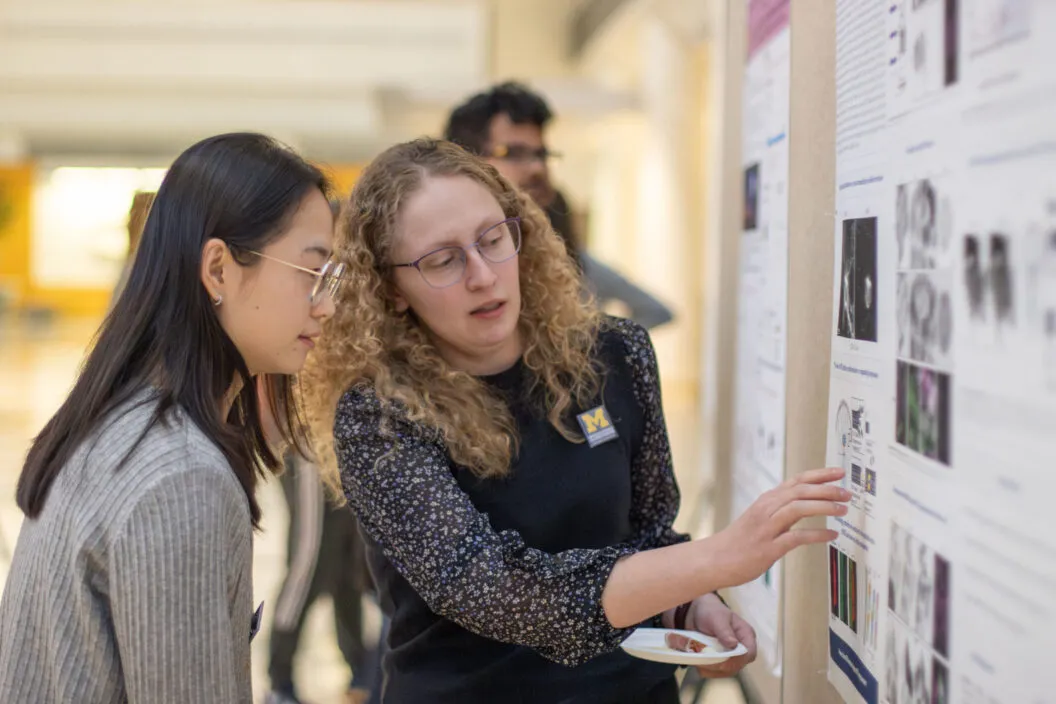 Fellows explaining a poster